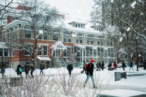 Students walking on campus in winter during the day